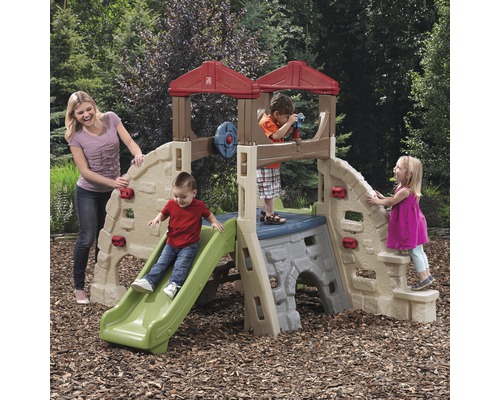 Aire de jeux avec toboggan, mur d''escalade et tour d''observation pour enfants dans le jardin.