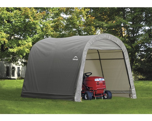 Abri couvert avec une tondeuse à gazon à l''intérieur.