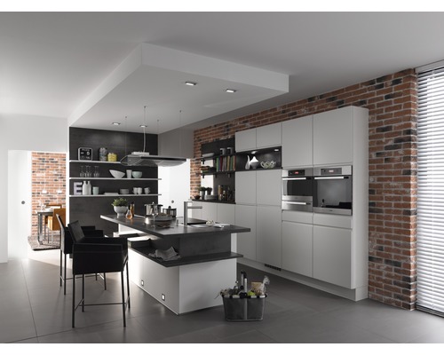 Cuisine lumineuse avec îlot de cuisson, mur en briques et appareils modernes