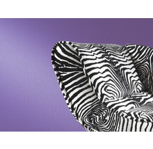 Fauteuil à motif zébré devant un mur violet