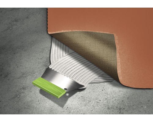 Application d''adhésif sur un revêtement de sol avec une spatule