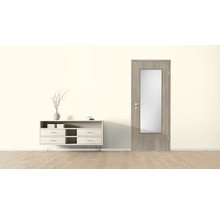 Séjour avec commode et porte intérieure avec insert en verre