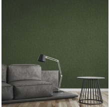 Salon avec canapé, lampadaire et table d''appoint devant un mur texturé