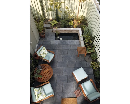 Vue aérienne d''un jardin avec des dalles en pierre, un bassin et un coin salon