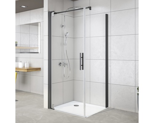 Cabine de douche avec cadre noir et robinetterie de douche dans une salle de bain moderne