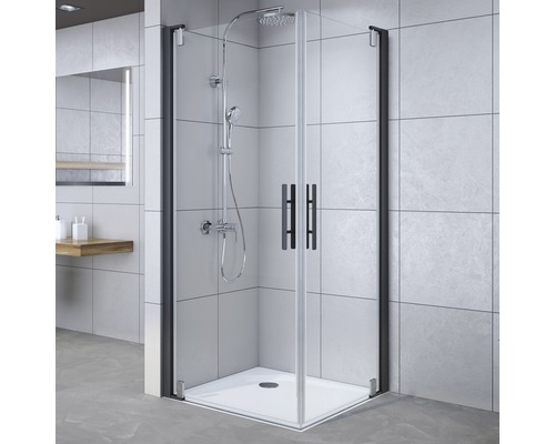 Cabine de douche d''angle avec receveur et cadre noir dans la salle de bain.