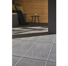 Terrasse avec carrelage gris, coin salon et table