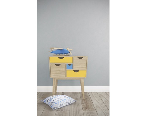 Nachttisch mit Schubladen und Spielzeugflugzeug im Kinderzimmer.