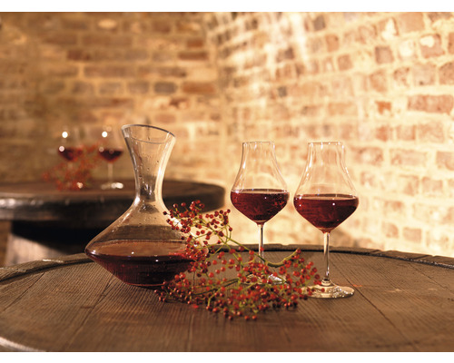Carafe à décanter et verres à vin sur tonneau en bois dans une cave à vin
