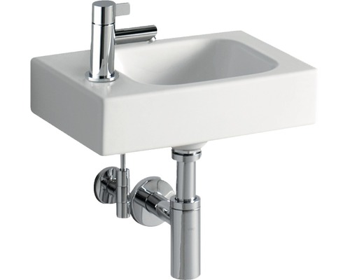 Weisses Aufsatzwaschbecken mit Chromarmatur und Siphon