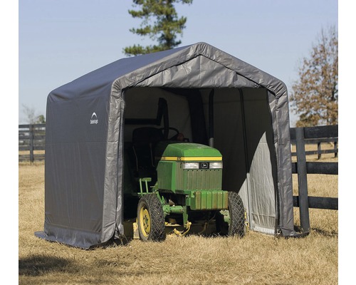 Abri gris avec une tondeuse à gazon