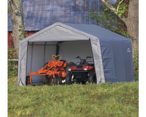 Abri d''équipement gris avec tracteur et quad