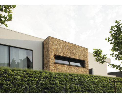 Vue extérieure d''une maison moderne avec façade en pierre naturelle et pente végétalisée