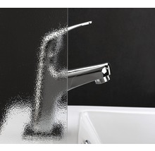 Gros plan d''un lavabo avec robinet derrière un verre texturé