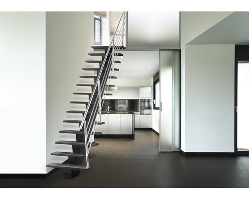 Pièce lumineuse avec escalier, cuisine et porte coulissante