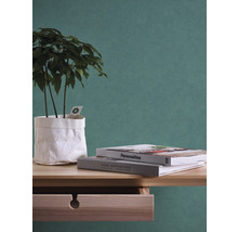 Scène décorative avec plante en pot en papier, livres et commode.