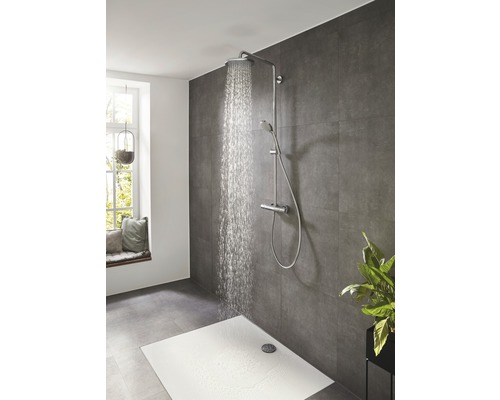 Système de douche avec douche de tête, douchette à main et mitigeur thermostatique dans une salle de bains avec des carreaux gris