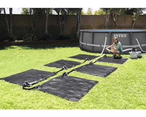 Installation de tapis solaires chauffants pour une piscine dans le jardin
