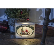 Bougie de Noël décorative avec motif Père Noël à côté d'un petit sapin de Noël