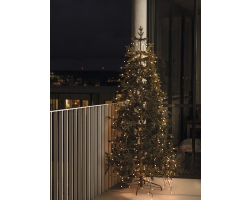 Rideau à LED pour arbre Konstsmide avec anneau Ø 11 cm Globes extérieur et intérieur lot de 240 ampoules couleur ambre Sapin de Noël artificiel avec éclairage sur un balcon.