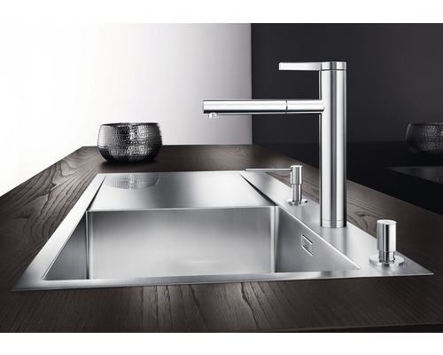 Évier en acier inoxydable avec robinetterie et distributeur de savon sur plan de travail foncé