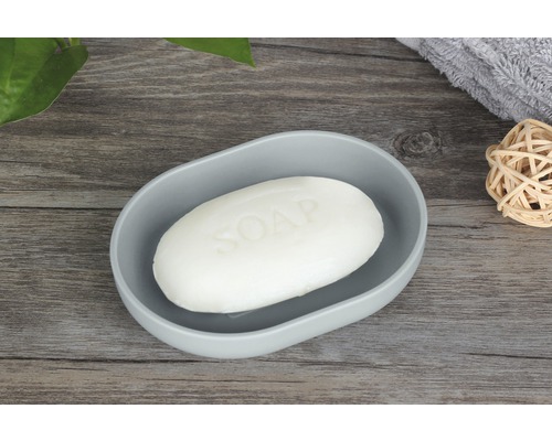 Porte-savon avec savon sur une table en bois