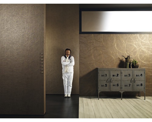 Exemple d''aménagement avec une commode et un homme devant un mur avec du papier peint