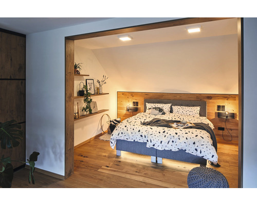 Chambre à coucher avec lit, tables de chevet, étagères et éléments en bois