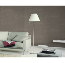 Salon avec canapé, lampadaire et papier peint à motifs pour une atmosphère chaleureuse