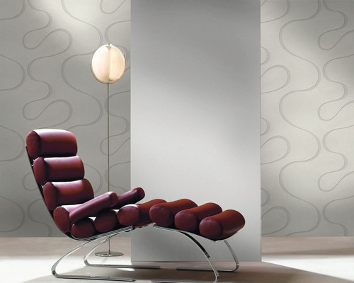 Salon avec fauteuil, lampadaire et papier peint à motifs