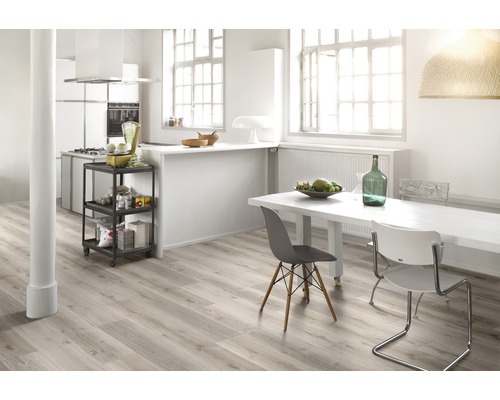 Cuisine et salle à manger claires et spacieuses avec plancher en bois, table à manger et chariot de cuisine