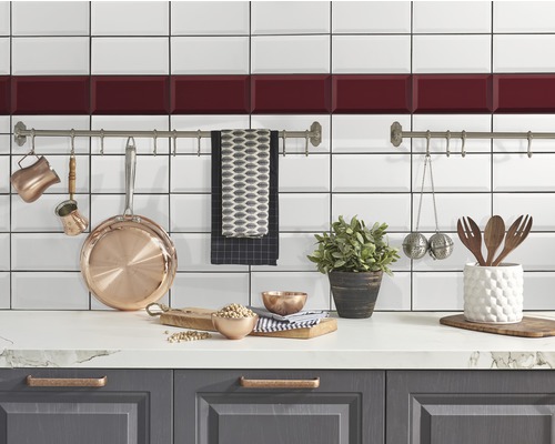 Scène de cuisine avec des carreaux blancs, des ustensiles de cuisine et des décorations sur un plan de travail