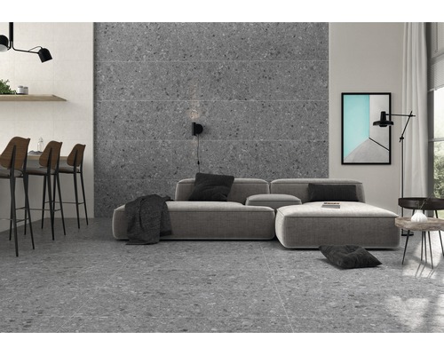 Salon avec carrelage terrazzo gris au sol et au mur