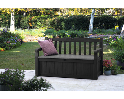 Banc de jardin avec espace de rangement et coussin dans le jardin
