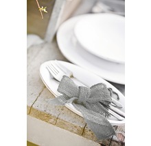 Gedeckter Tisch mit Tellern, Besteck und Schleife aus Sackleinen