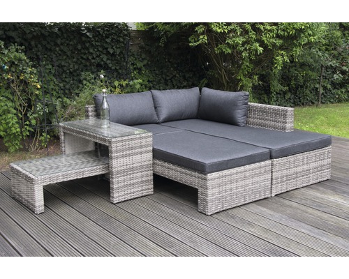 Gartenlounge-Set mit Tisch auf einer Holzterrasse vor einer grünen Hecke