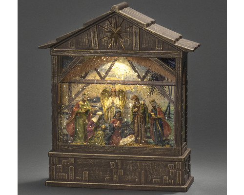 Crèche illuminée dans une étable en bois