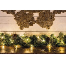 Arrangement décoratif avec couronne de jute, vert sapin, guirlande lumineuse et pommes de pin