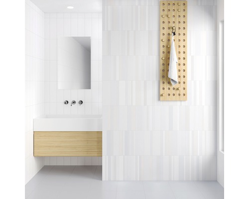 Helles Badezimmer mit Waschbeckenunterschrank, Spiegel, Handtuchhalter und weissen Fliesen