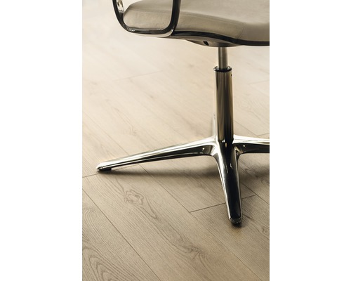 Vue détaillée d''une chaise de bureau avec pied chromé sur un plancher en bois