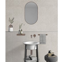 Badezimmer mit Waschbecken, Spiegel und Fliesen