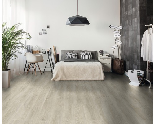 Schlafzimmer mit Bett, Schreibtisch und hellem Holzboden