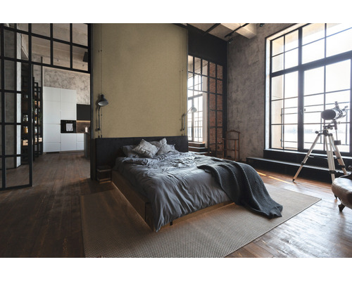 Chambre lumineuse de style loft avec lit, tapis et grandes fenêtres