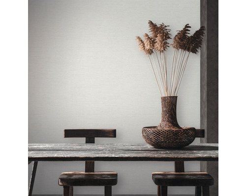 Papier peint clair et structuré dans la salle à manger avec table en bois et décoration