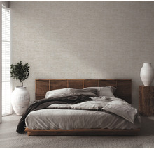 Schlafzimmer mit Doppelbett, Nachttisch und Zimmerpflanze in Vase