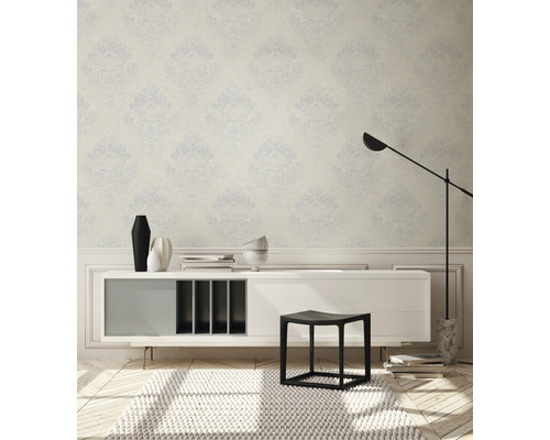 Innenraum mit gemusterter Tapete, Sideboard, Hocker und Teppich