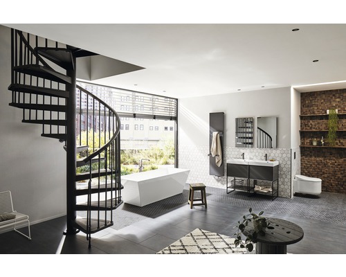 Salle de bains lumineuse avec escalier en colimaçon, baignoire, meuble-lavabo et radiateur mural