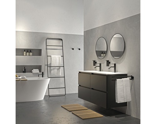 Salle de bains avec baignoire, lavabo, miroirs et échelle à serviettes