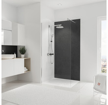 Salle de bain lumineuse avec cabine de douche, lavabo et tapis blanc