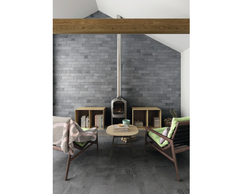 Wohnzimmer mit Ziegelwand, Kaminofen, Holzbalken und Holzboden